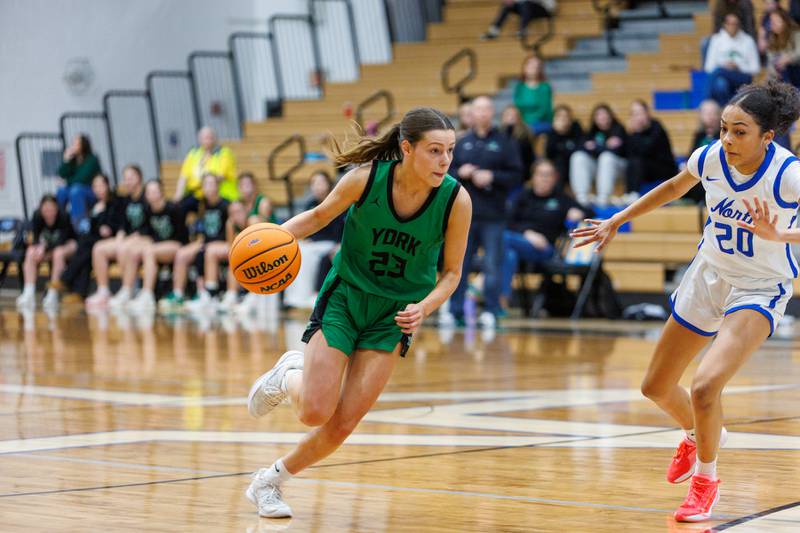 York's Kayla Callahan runs a play against St. Charles North's Sydney Johnson at the Class 4A Regional Final on Thursday, Feb.19,2026 in St. Charles.