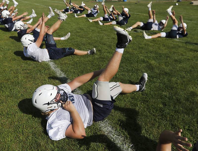 Cary-Grove's Jack Hissong works on core conditioning during Cary-Grove’s first football practice of the upcoming season on Monday, August 11, 2025, at Cary-Grove High School.