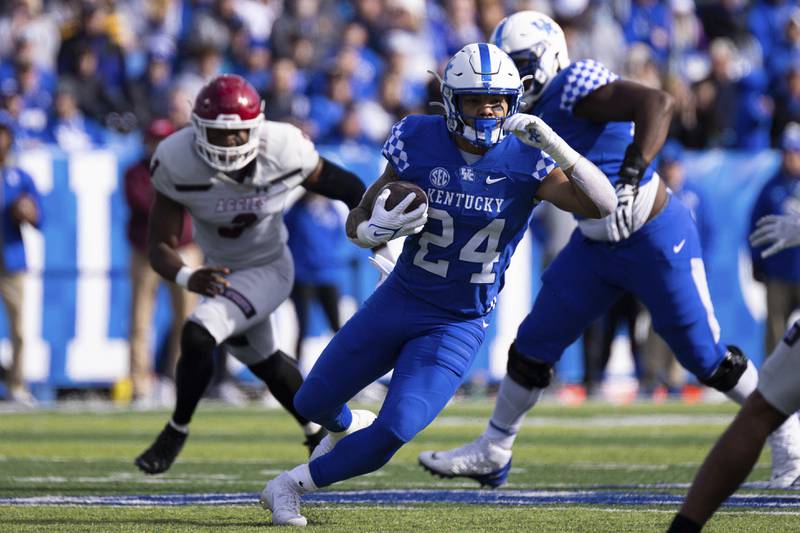 FILE - Kentucky running back Chris Rodriguez Jr. (24) runs the ball against New Mexico State during an NCAA college football game in Lexington, Ky., Saturday, Nov. 20, 2021. Kentucky coach Mark Stoops said Monday, Sept. 12, 2022, that leading rusher Chris Rodriguez Jr. will return from an unspecified absence on Oct. 1 for the No. 9 Wildcats’ Southeastern Conference matchup at No. 20 Mississippi. (AP Photo/Michael Clubb, File)