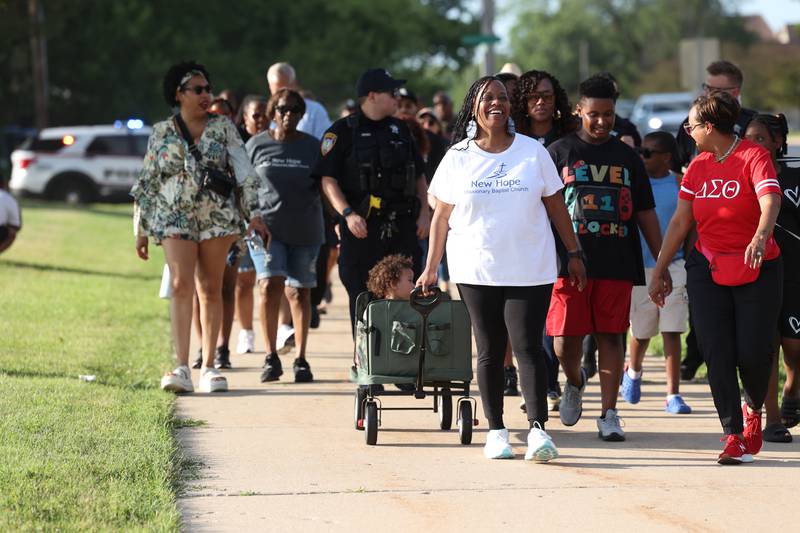 Marchers chant slogans as they make their way through the walk Friday, July 18, 2025, during the DeKalb Peace Walk and Rally. The event, which featured a march, food vendors and music, was held to encourage the community to work together against gun violence.