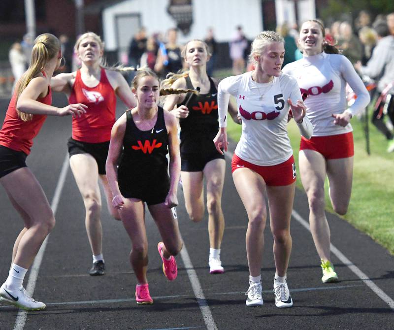Oregon's Jillian Hammer (right) hands the baton off to Skylar Bishop on the final exchange of the 4x400 relay at the 1A Winnebago Sectional on Wednesday, May 13, 2026.