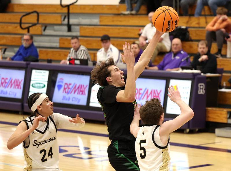 Crystal Lake South's Tony Santarelli grabs a rebound between Sycamore's Unique Shaw (left) and Preston Picolotti during their sectional semifinal game Tuesday, March 4, 2025, at Rochelle High School.