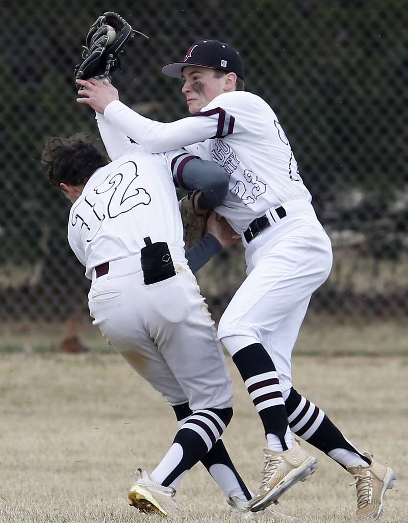 Marengo's Carter Heimsoth, right, hangs on to the ball as he collides with his teammate, Caden Vogt, left, during a non-conference baseball game Wednesday, March 30, 2022, between Marengo and Hampshire at Marengo High School.