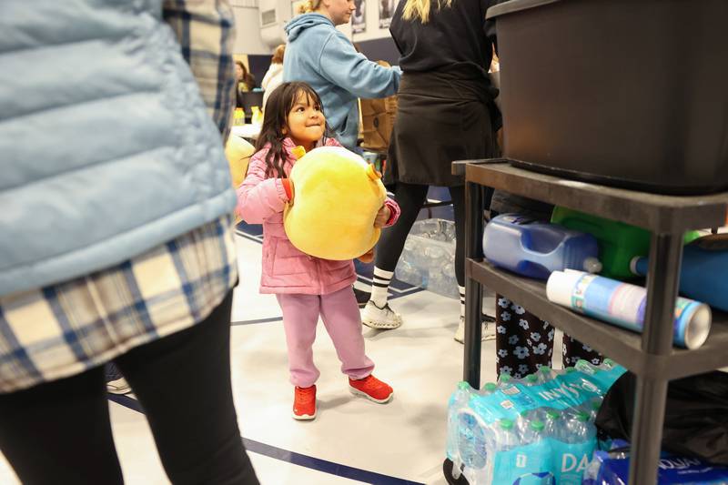 Four-year-old Azucena Aguilar, of Kankakee, chooses a toy from the donations at Grace Christian Academy on Thursday, March 12, 2026, following the EF-3 tornado that tore through Kankakee County on March 10. The school, which is on the outskirts of Aroma Township along Waldron Road, canceled classes in order to become a supply and meal hub for those impacted by the storm.
