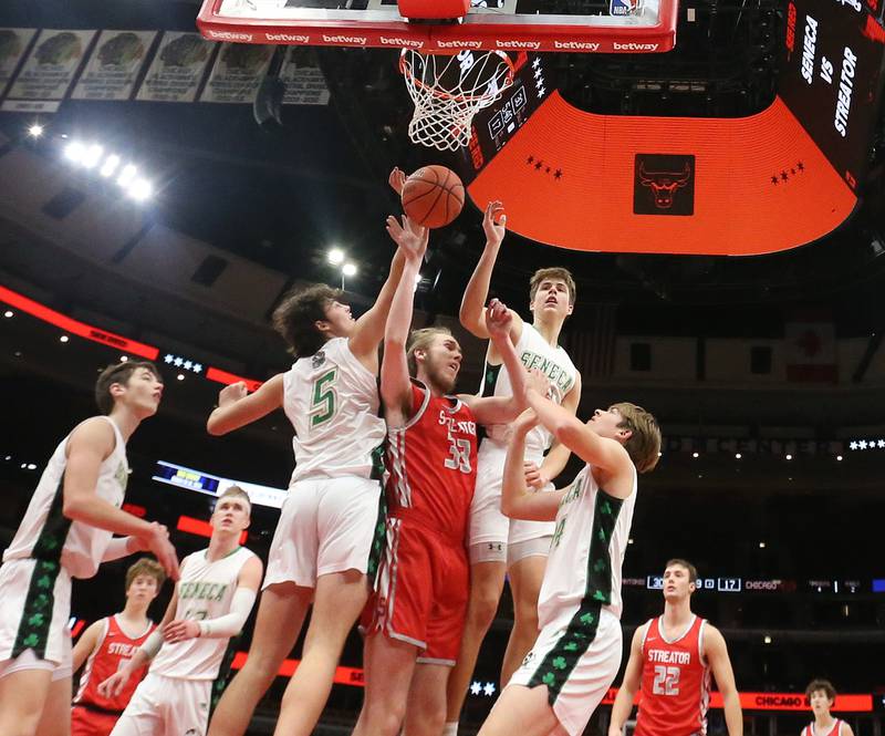 Streator's Quinn Baker hits the ball out of the way of Seneca defenders Kysen Klinker, Lane Provance and Cameron Shriey during a game on Tuesday, Dec. 21, 2023 at the United Center in Chicago.