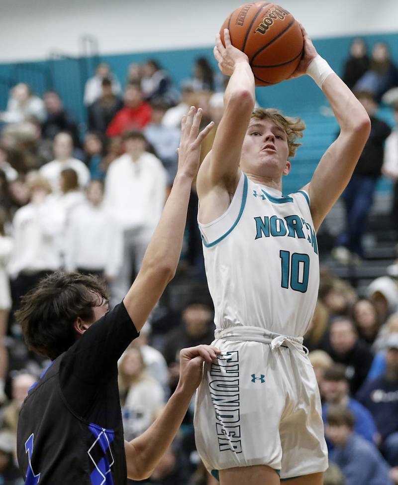 Woodstock North's Trevor Mark shoots the ball over Woodstock's Collin Greenlee during a Kishwaukee River Conference boys basketball game on Friday, Jan. 5. 2024, at Woodstock North High School.