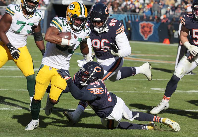 Green Bay Packers running back Aaron Jones pulls away from Chicago Bears cornerback Jaylon Johnson during their game Sunday, Dec. 4, 2022, at Soldier Field in Chicago.