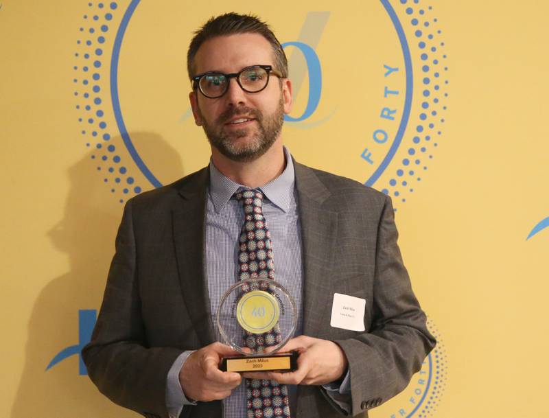 Zach Milus poses for a photo with his award during the 40 Under Forty awards banquet on Thursday, March 21, 2024 at Westclox in Peru.