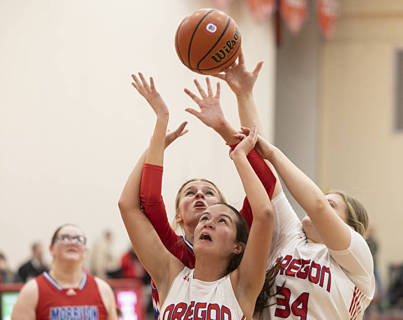 Morrison’s Avery White and Oregon’s Sarah Eckhardt and Madelyn Wendt work for a rebound Wednesday, Jan. 17, 2024 at Oregon High School.