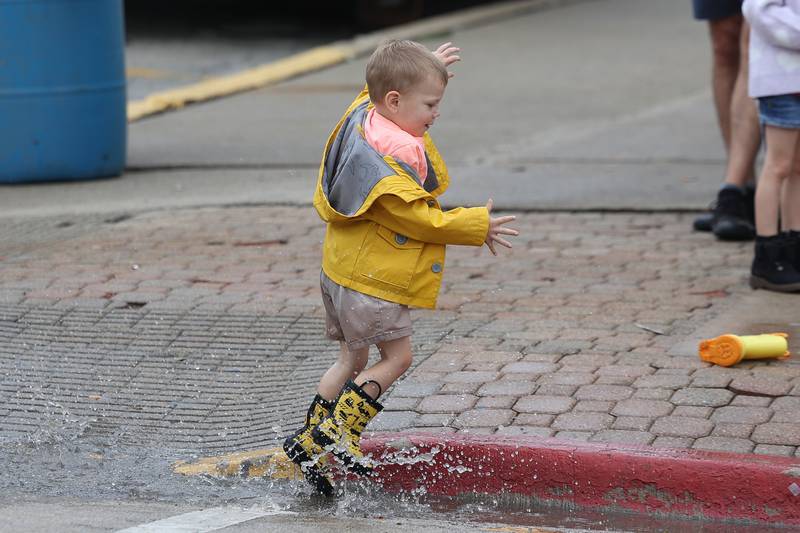 Wyatt Wills, 3, plays in a puddle at the 75th Annual Grundy County Corn Festival on Saturday, Sept. 28, 2024 in downtown Morris.