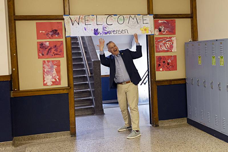 Congressman Eric Sorensen celebrates a handmade sign welcoming him to Wallace School Wednesday, March 27, 2024. The sign was made by younger members of the Head Start program.