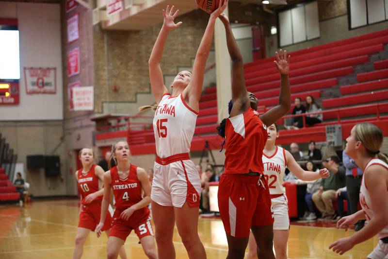 Ottawa's Hailey Larsen and Streator's Shantell Morton reaches up to grab a rebound during the Lady Pirate Holiday Tournament on Wednesday, Dec. 20, 2023 in Kingman Gym.