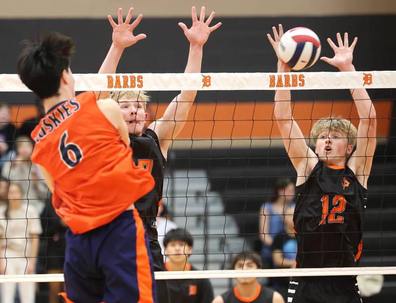 DeKalb’s Grady Fowler (left) and Gregory Kubitz try to block Tuesday, April 21, 2026 during their match against Naperville North JV at DeKalb High School.