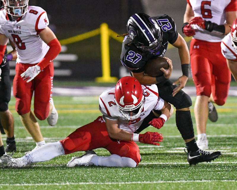 Hinsdale Central's Patrick Connors (2) brings down Downers Grove North's ball carrier Kevin Jay Jr. (27) during the game on Friday Sept. 12, 2025, held at Downers Grove North High School.