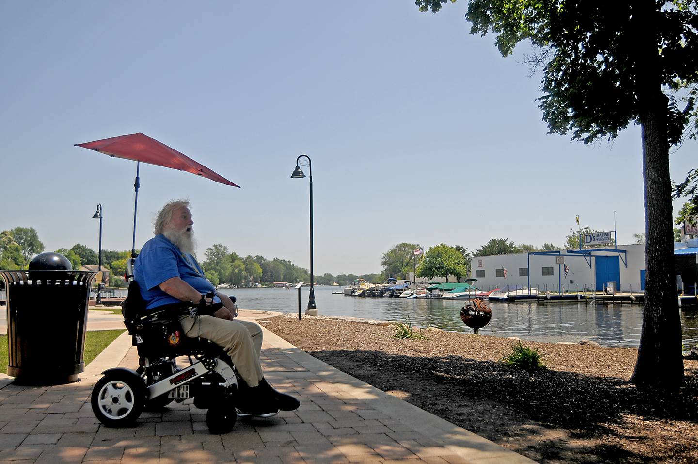 Jim Macintyre takes advantage of a cool breeze and the shade from a large tree to keep cool Tuesday, June 14, 2022, at Millers Point in McHenry, as temperatures in the McHenry County area reached the mid-90’s.