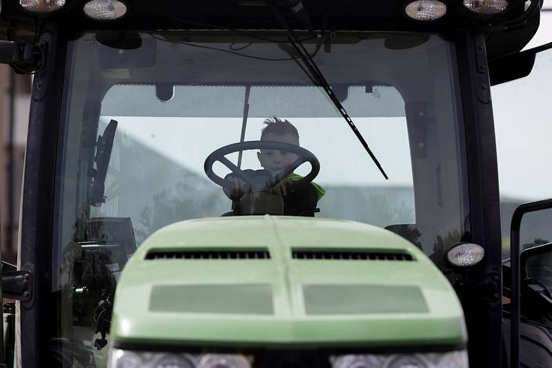 A young man checks out the cab of a tractor Thursday, May 7, 2026, at a display of farming machinery during Sterling High School’s Farmapalooza.