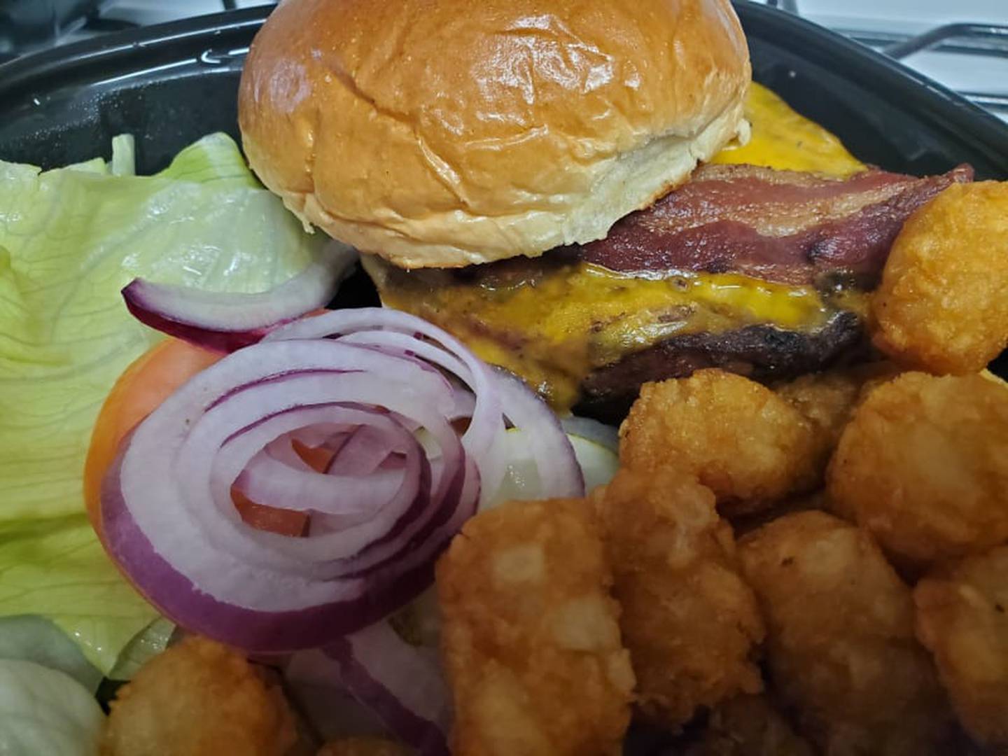 Jameson's Pub in Joliet has a bacon cheddar burger for $19 and a side of tater tots for $2. The veggies were placed on the side and remained crisp.