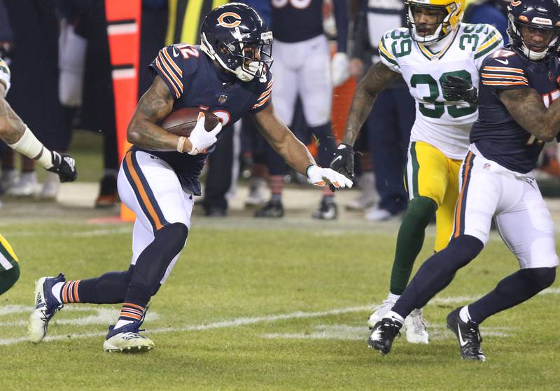 Chicago Bears wide receiver Allen Robinson (12) makes a catch between two Packers during their game Sunday at Soldier Field in Chicago.