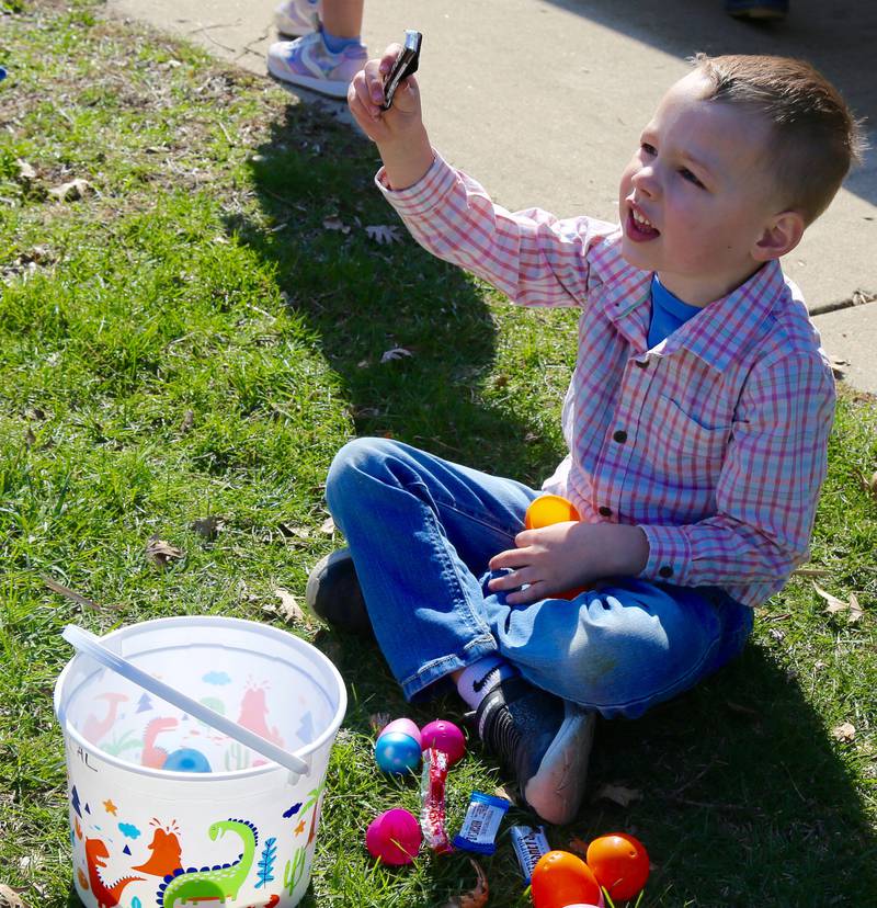 Five year old Cal Carpenter shows his mom candy that he got in an egg at the Elburn Lions Easter Egg Hunt on Saturday, April 12, 2025 in Elburn.