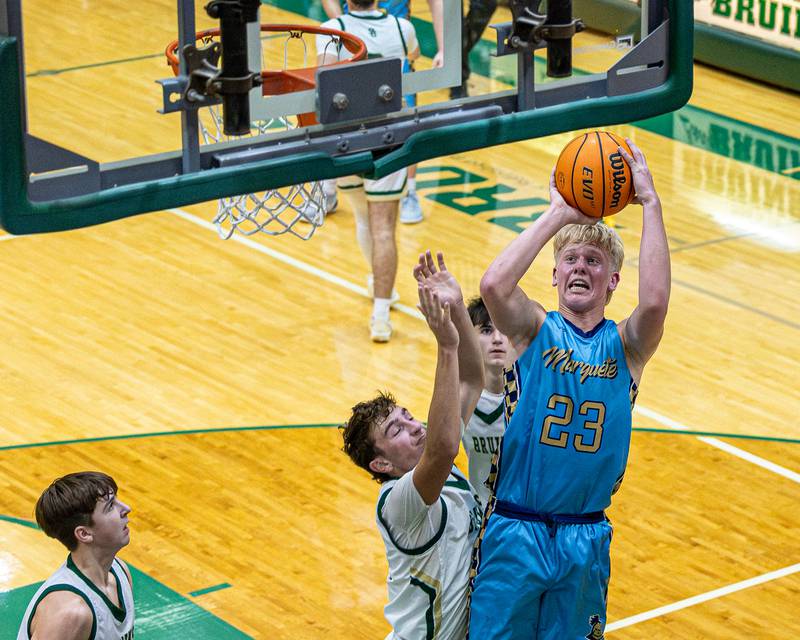 Luke McCullough (23) of Marquette shoots basketball over Gino Ferrari (4) of St. Bede on Friday, January 16, 2026 at St. Bede Academy in Peru.