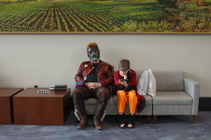 Jed Harris, dress as Guardian of the Galaxies' Star-Lord, and his son Jacob, 12-years, dressed as the anime character Naruto Shippuden, lounge between events at C2E2 Chicago Comic & Entertainment Expo on Friday, March 31, 2023 at McCormick Place in Chicago.