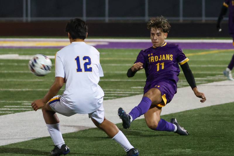 Cesar Casas of Mendota kicks ball past player of Aurora Central Catholic High School on Saturday, November 2, 2024 at Richard E. Phalen, SR. Field in Mendota.