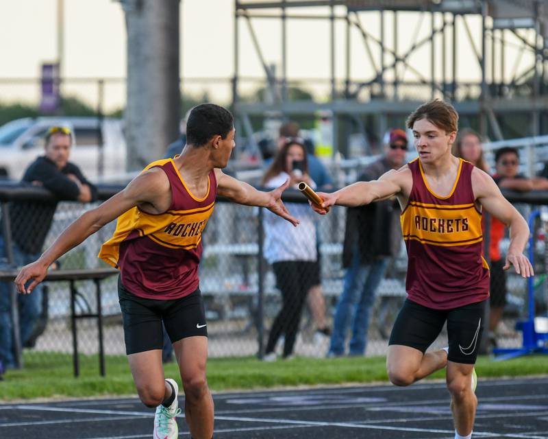 Richond-Burton High School 200 meter relay runner Joe Kyes, right, hands the baton off to teammate Jayson Wold during the Kishwaukee River Conference track meet held on Tuesday May 7, 2024, held at Plano High School.