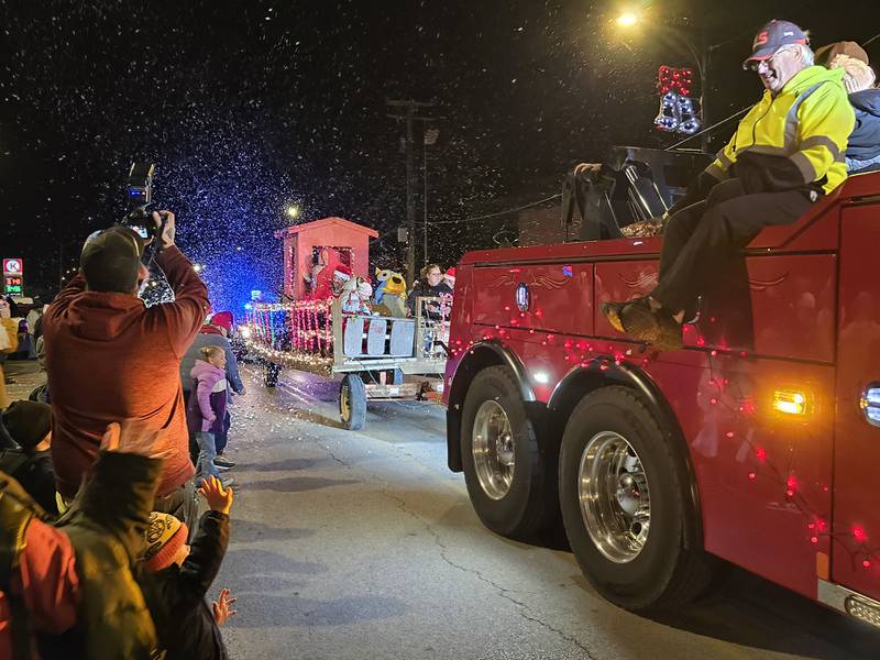 A snow machine creates a winter scene Saturday, Dec. 7, 2024, during the Holiday Magic Lighted Santa Parade route in Marseilles.