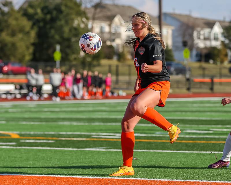 St. Charles East's Mackenzie Loomis (6) winds up to kick on goal during soccer match between Burlington Central at St. Charles East.  March 28, 2023.