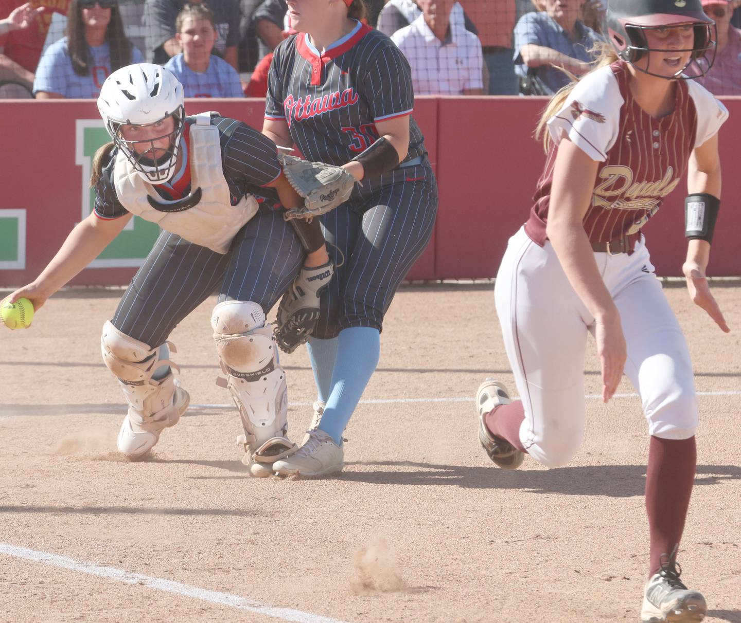Ottawa catcher Bobbi Snook throws to first to force out Dunlap's Addy Kearns during the Class 3A semifinal game on Tuesday, May 26, 2026 at the L-P Athletic Complex in La Salle.