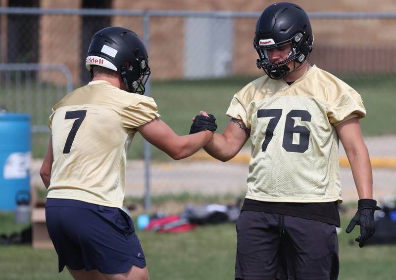 Sycamore’s Cooper Bode (left) and Owen DePauw warm up Monday, Aug. 11, 2025, at the start of their first fall practice at the school.