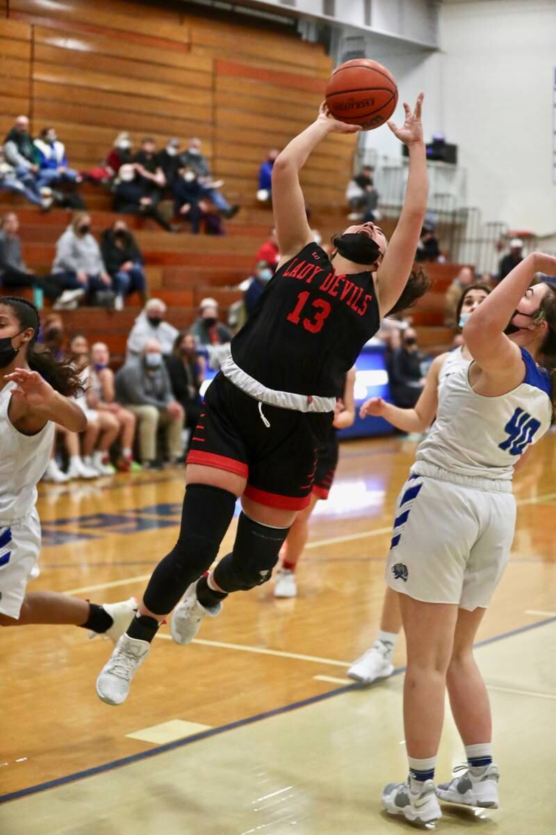 Hall's McKenna Christiansen shoot's over Princeton's Morgan Coleman Monday night.