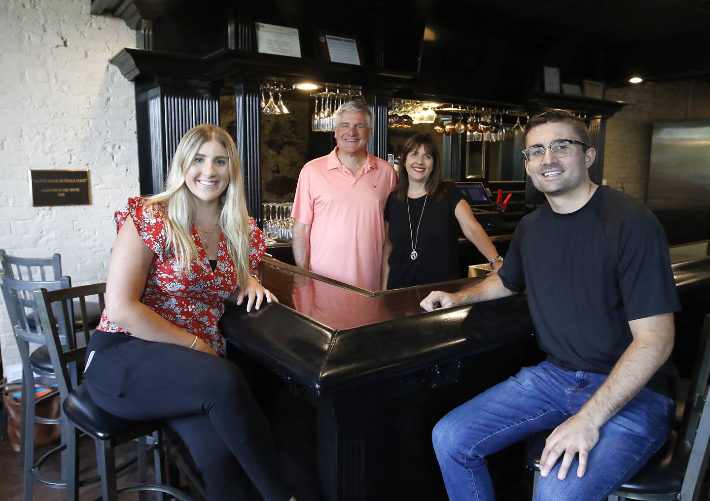 Bill and Tammy Linardos (center) with their children, Sophia and Billy, on Wednesday, Sept. 11, 2024, as they prepare to open Squire on the Square restaurant in the old Public House space at the Woodstock Old Courthouse.