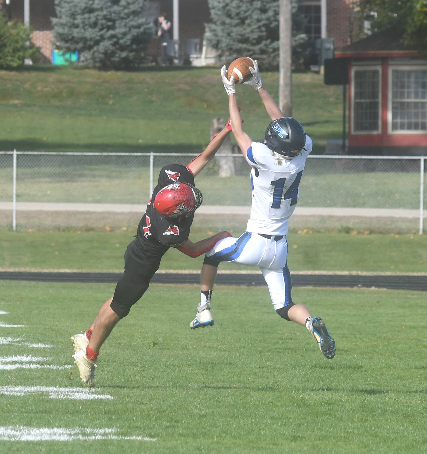 EPC's Max McCullough catches a pass for a big gain as Fulton's Ryan Eads tries to break up the play during Saturday, Oct. 15 action in Fulton.