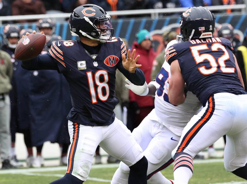 Chicago Bears quarterback Caleb Williams gets rid of the ball as center Drew Dalman blocks New York Giants defensive tackle Rakeem Nunez-Roches Sunday, Nov. 9, 2025, during their game at Soldier Field in Chicago.