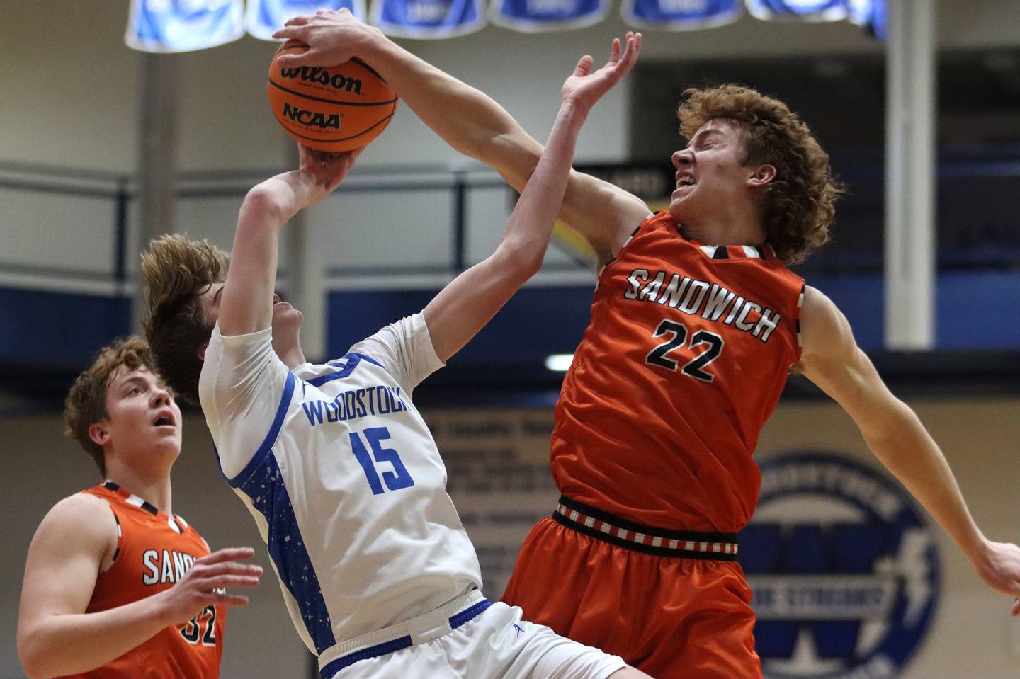 Woodstock’s Liam Laidig, left, tussles with Sandwich’s Dom Rome in varsity boys basketball on Tuesday, Feb. 11, 2025, at  Woodstock High School in Woodstock.