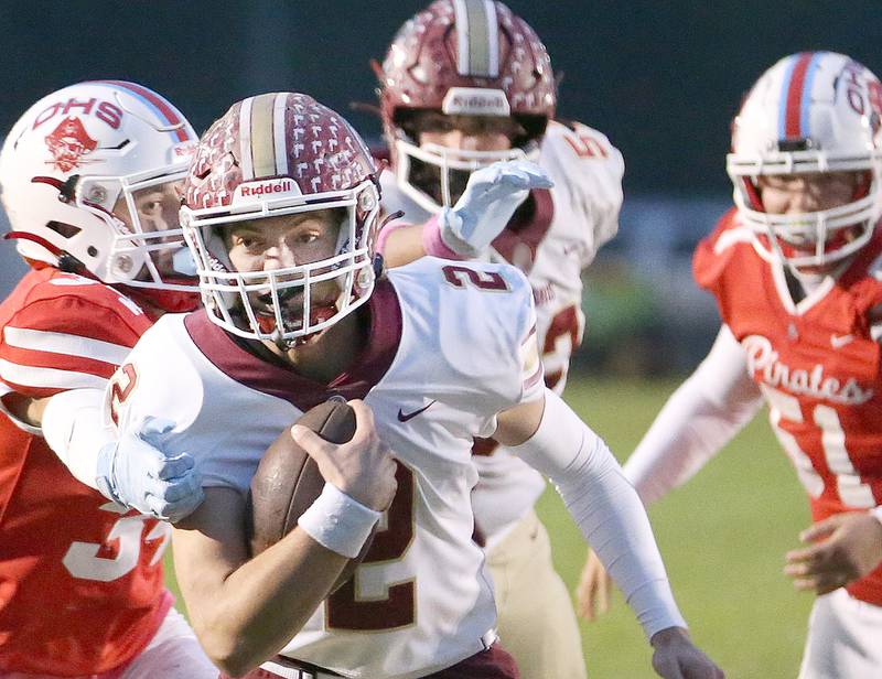 Morris quarterback Carter Button runs the ball past Ottawa's Tyce Kubiak and teammate Ethan Day on Friday, Oct. 13, 2023 at King Field.