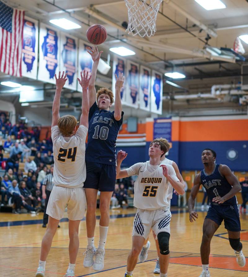Oswego East's Noah Mason (10) shoots the ball in the post over Neuqua Valley's Colin Gerrity (24) during a hoops for healing basketball tournament game at Oswego High School on Friday, Nov 24, 2023.