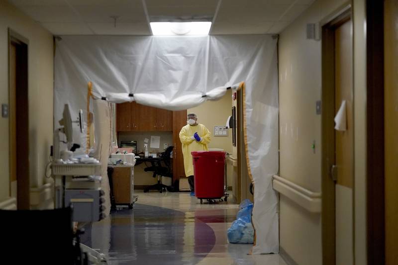FILE - Dr. Shane Wilson stands inside a section of Scotland County Hospital set up to treat COVID-19 patients Tuesday, Nov. 24, 2020, in Memphis, Mo. As of Monday, Feb. 14, 2022, health care workers in 24 states, all but three of whom voted for former President Donald Trump in 2020, will be required to have received their first vaccine dose or an exemption. At the hospital about 25% of the 145 employees remain unvaccinated and 30 of them have been granted exemptions. (AP Photo/Jeff Roberson, File)