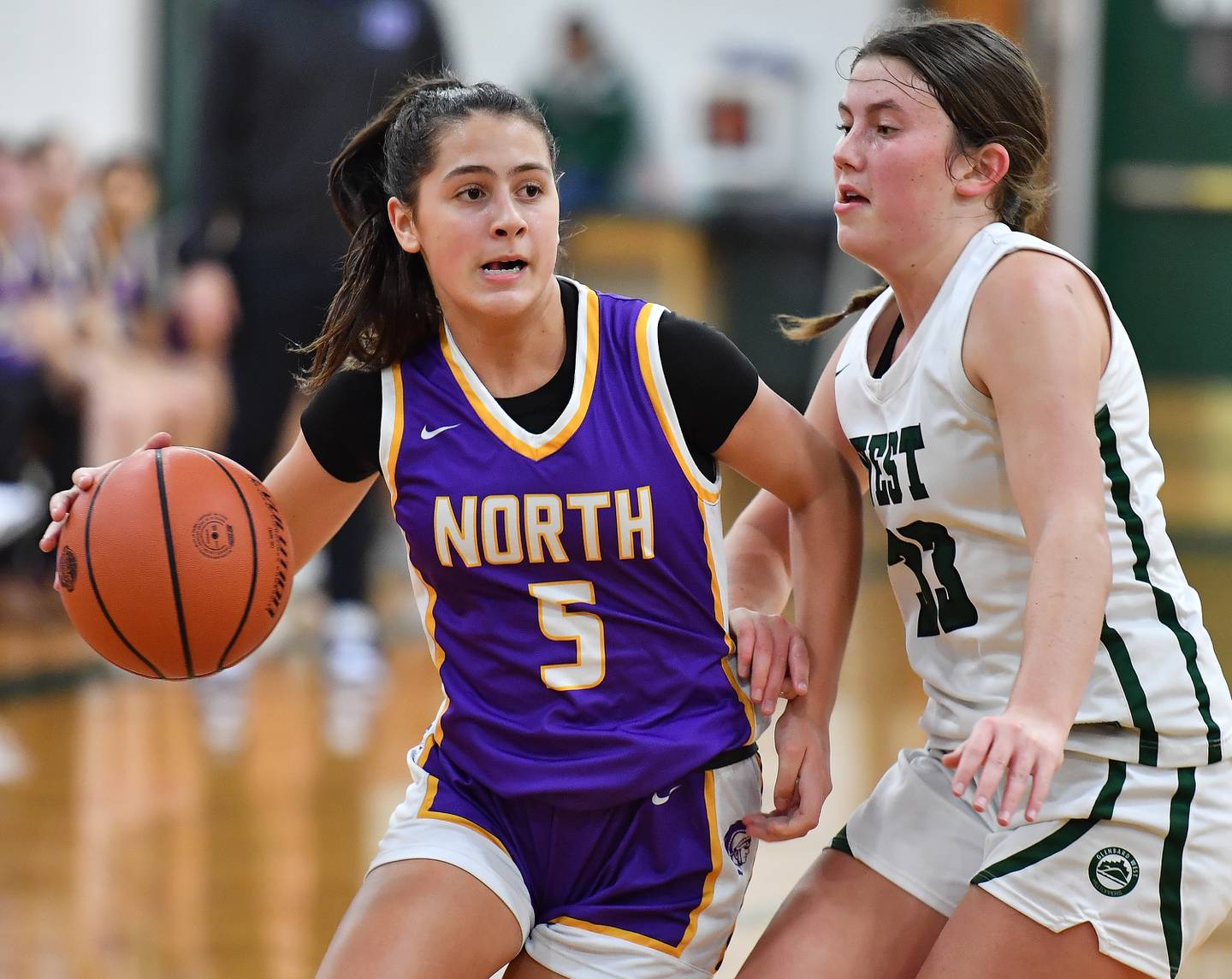 Glenbard West's Sydney Nimsakont (22) drives the baseline past Downers Grove North's Abby Gross during a game on Dec. 5, 2023 at Glenbard West High School in Glen Ellyn.