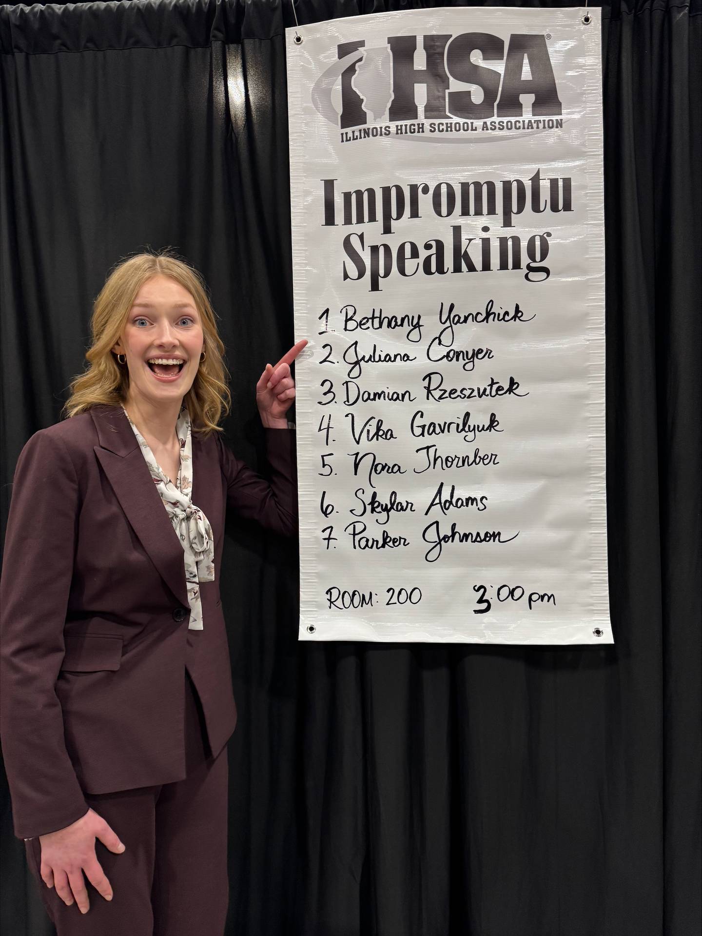 Bethany Yanchick stands by the poster announcing she had qualified for the final round of Impromptu Speaking at the State Speech Competition in Peoria.
Feb. 23, 2025