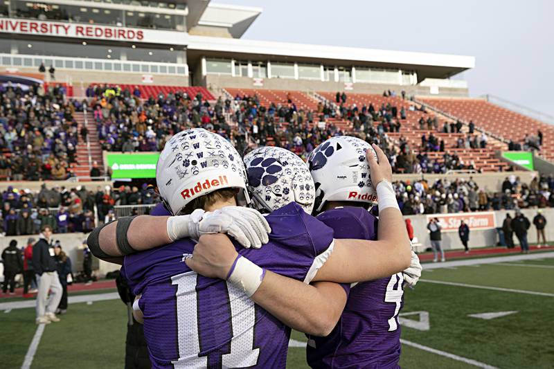 The Wilmington Wildcats celebrate their 28-3 win over Athens Friday, Nov. 24, 2023 in the 2A state football championship game at Hancock Stadium in Normal.