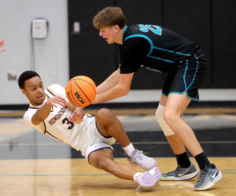 Hononegah's Caleb Hart passes the ball as Woodstock North's AJ Cohen tries to steal the ball during the 2025 Hoops for Healing tournament basketball game on Wednesday, Nov. 26, 2025, at Woodstock North High School.