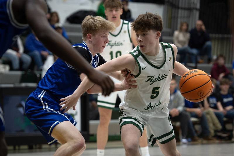 Bishop McNamara's Jayson Benton controls the ball as Newark's Kellen Westerfield, left, guards in a game on Friday, Feb. 20, 2026.