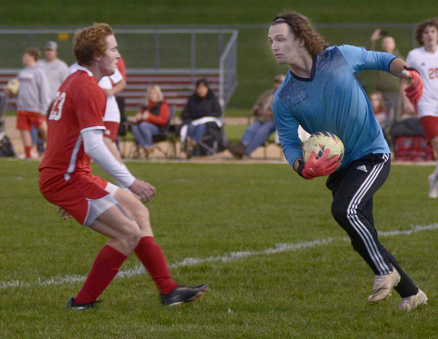 Streator keeper Noah Camp scoops up the ball in front of Ottawa's Evan Snook in the first half of Tuesday's match at Ottawa.