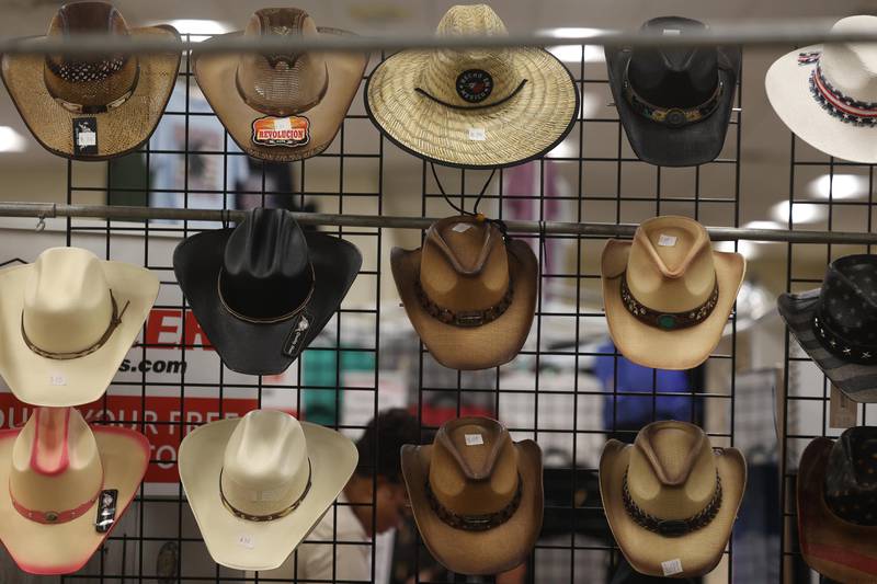 Cowboy hats hand on a rack for sale at the Will County Fair on Sunday, August 25, 2024 in Peotone.