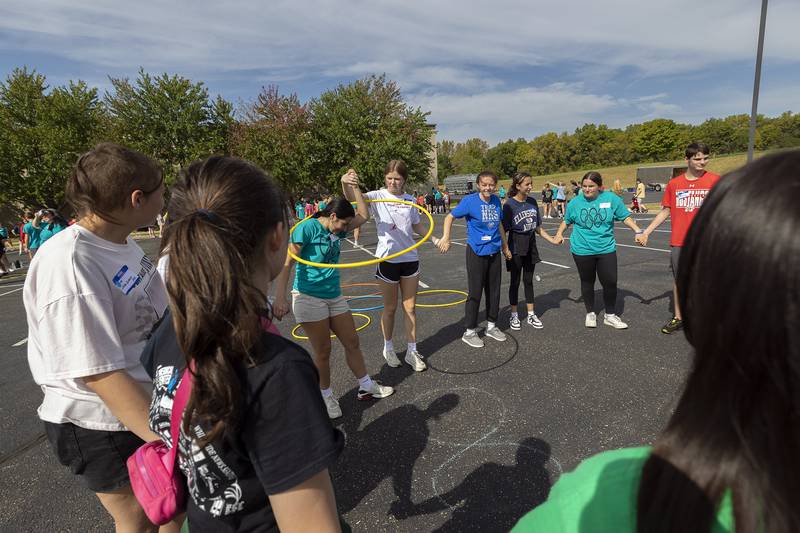 Having to work together to accomplish a task, students in BLIND work their way through an exercise hoop Thursday, Sept. 19, 2024.