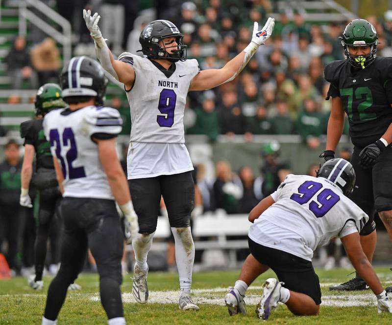 Downers Grove North’s William Vala (9) signals to Trojan fans to makes some noise during a Class 7A second-round playoff game against Glenbard West on November 8, 2025 at Glenbard West High School in Glen Ellyn.