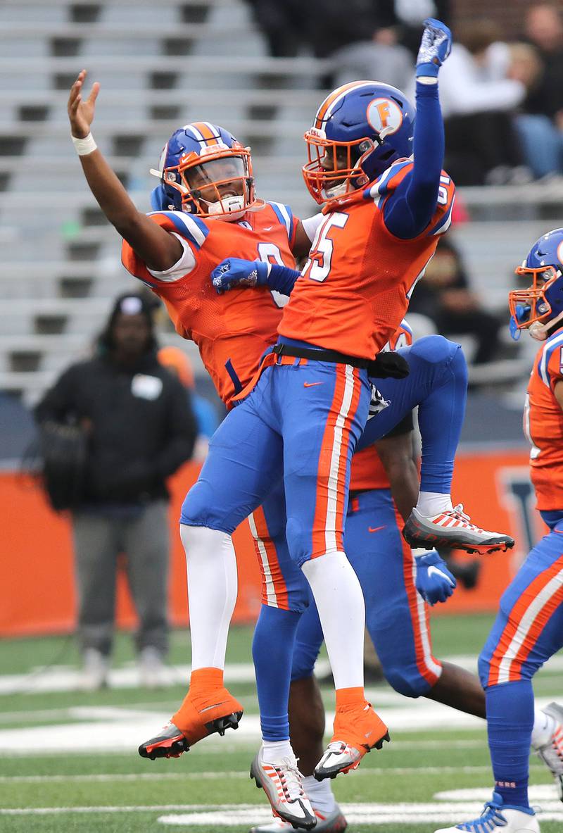 East St. Louis' Robert "Pops" Battle (left) and Nazz Cobb celebrate a touchdown during their IHSA Class 6A state championship game against Prairie Ridge Saturday, Nov. 26, 2022, in Memorial Stadium at the University of Illinois in Champaign.