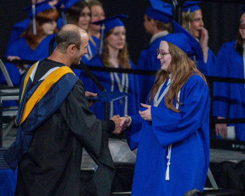 A St. Charles North graduates accepts a diploma on Monday, May 18, 2026, during the ceremony held at the Convocation Center in DeKalb.